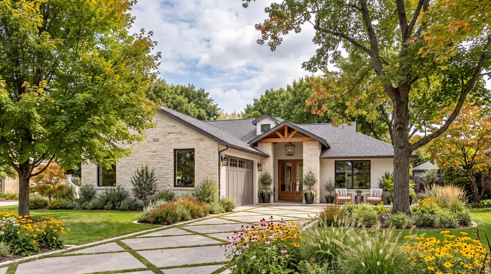 A light stone family home with mature trees and a landscaped yard
